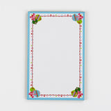 luxury christmas notepads with ornament and holly motifs against a white background.