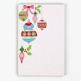 luxury christmas notepads with ornament and holly motifs against a white background.