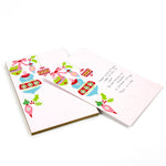 luxury christmas notepads with ornament and holly motifs against a white background.