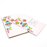 luxury christmas notepads with ornament and holly motifs against a white background.