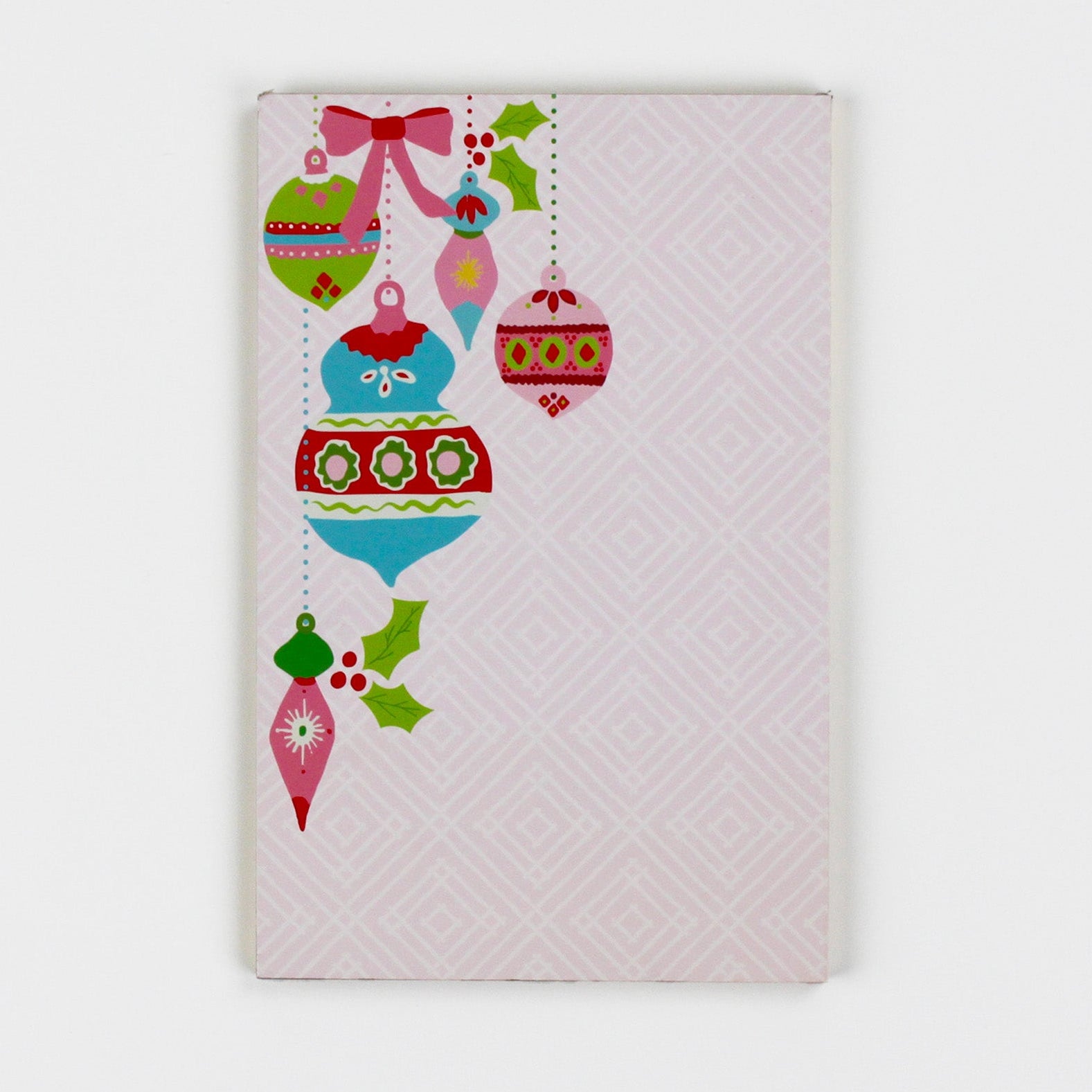 luxury christmas notepads with ornament and holly motifs against a white background.
