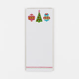 a skinny luxury christmas notepads with ornament and holly motifs against a white background.