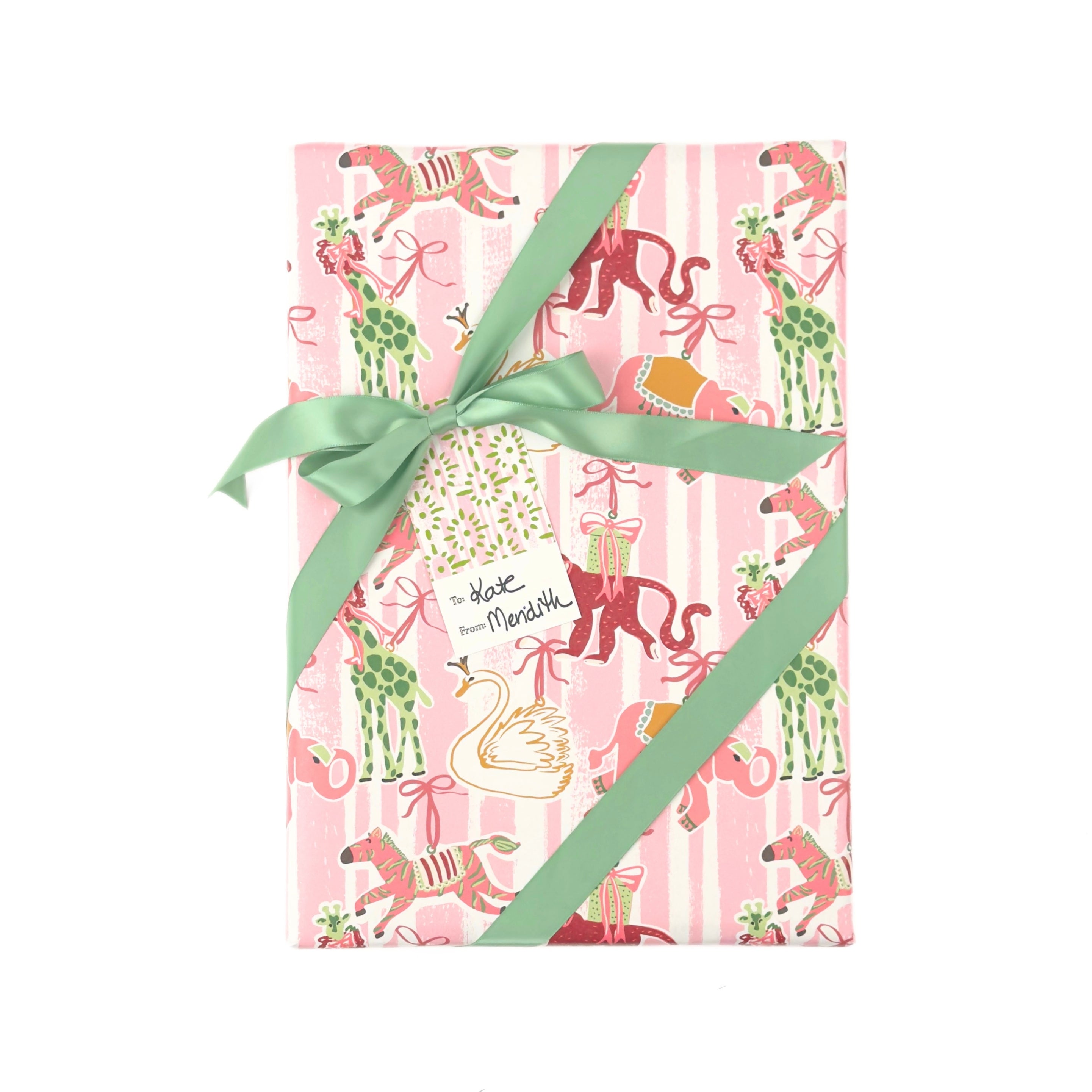 Whimsical Christmas gift wrap featuring festive giraffes, monkeys, zebras, and swans against playful pink stripes.