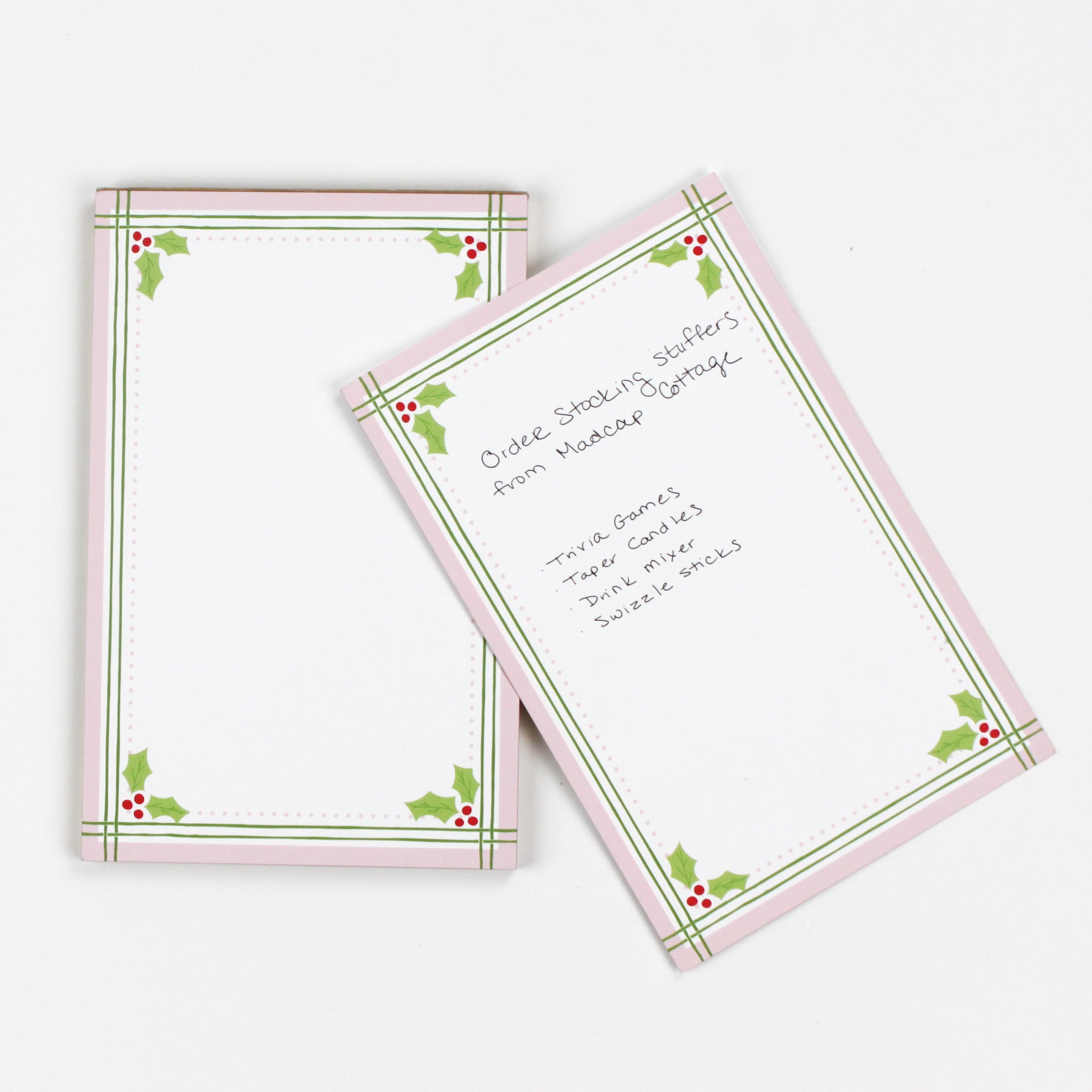 Christmas Holly notepad with pink border and green holly leaf design in a white background