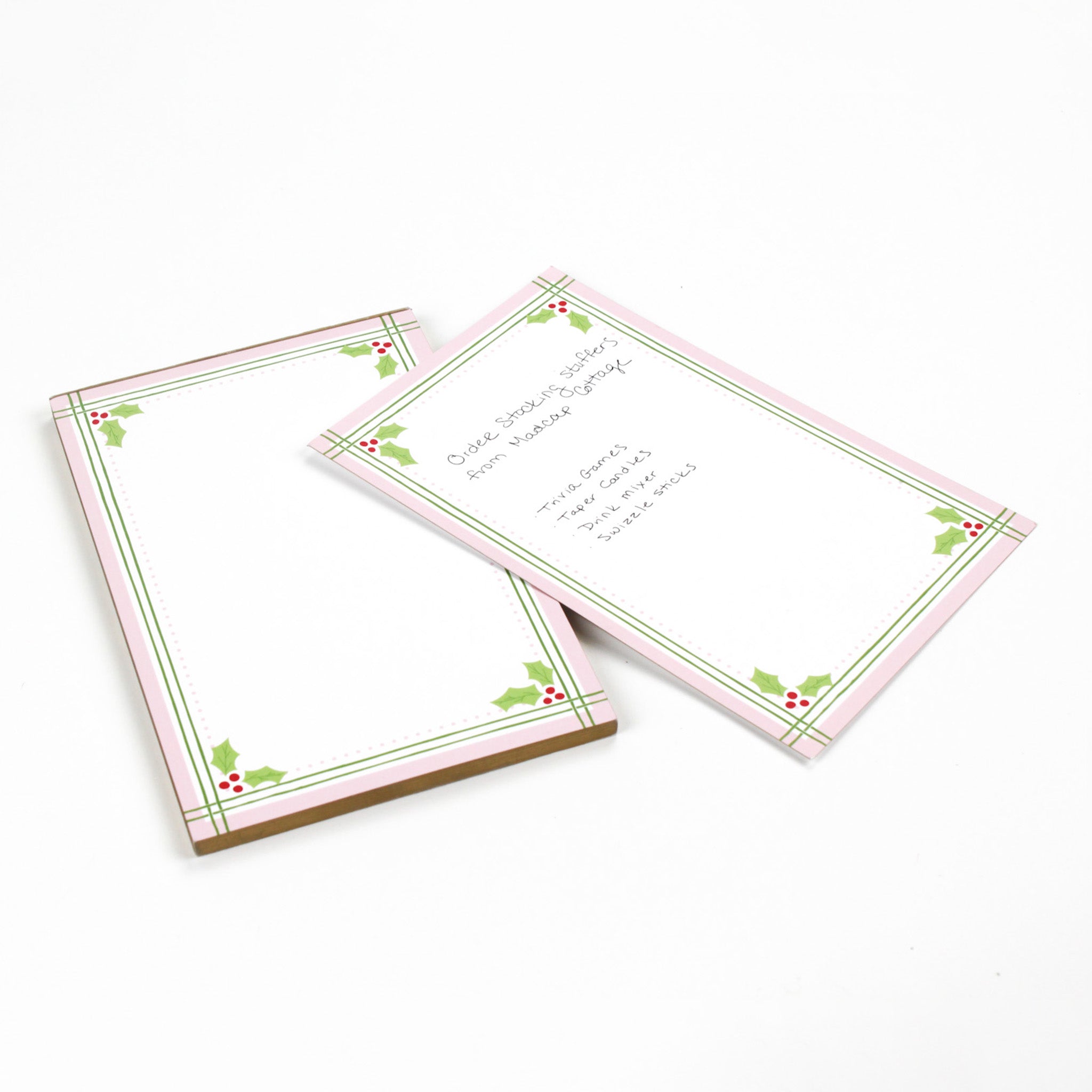 Christmas Holly notepad with pink border and green holly leaf design in a white background