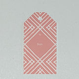 a gift tag with a geometric lattice pattern in pink, with a space for personalized message.