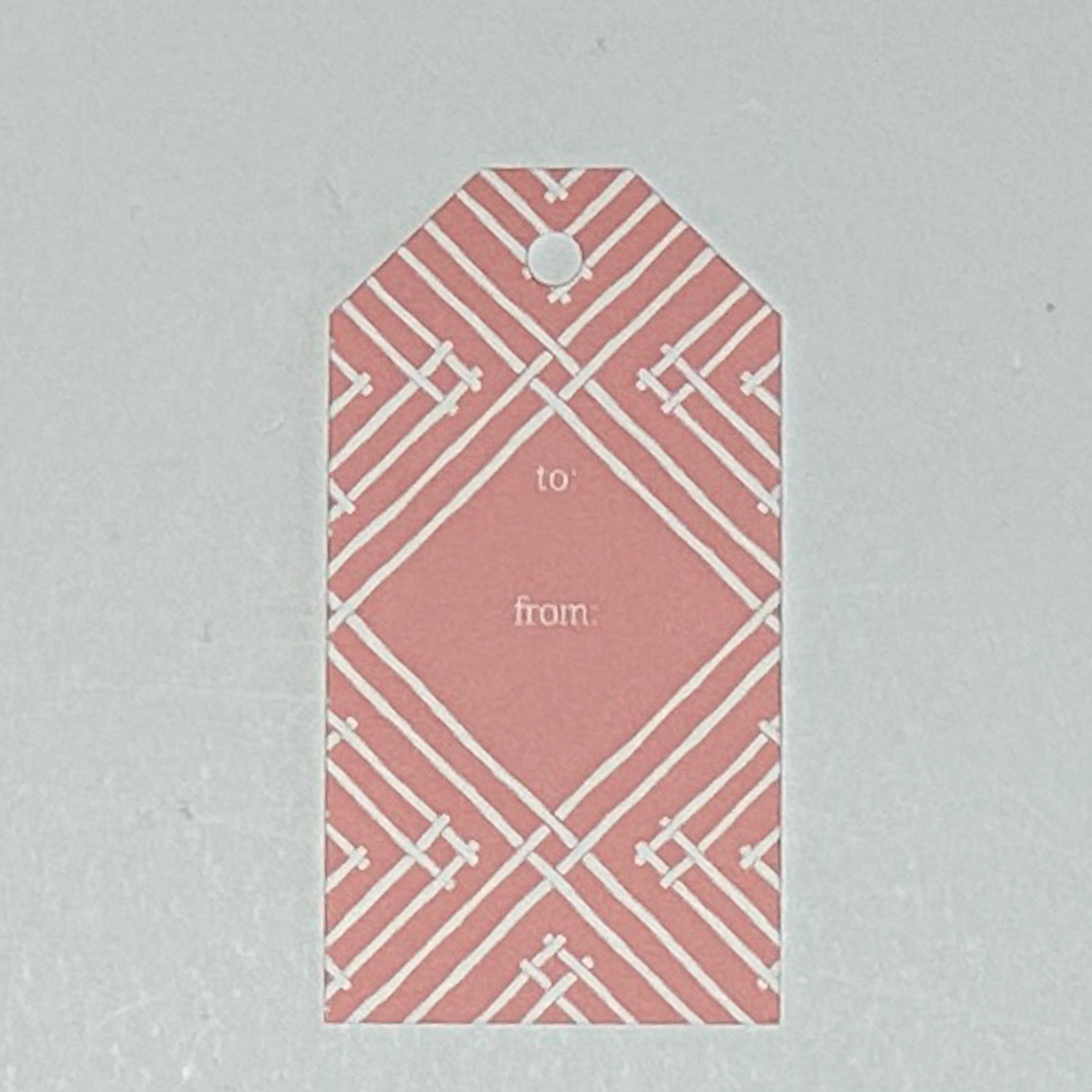 a gift tag with a geometric lattice pattern in pink, with a space for personalized message.