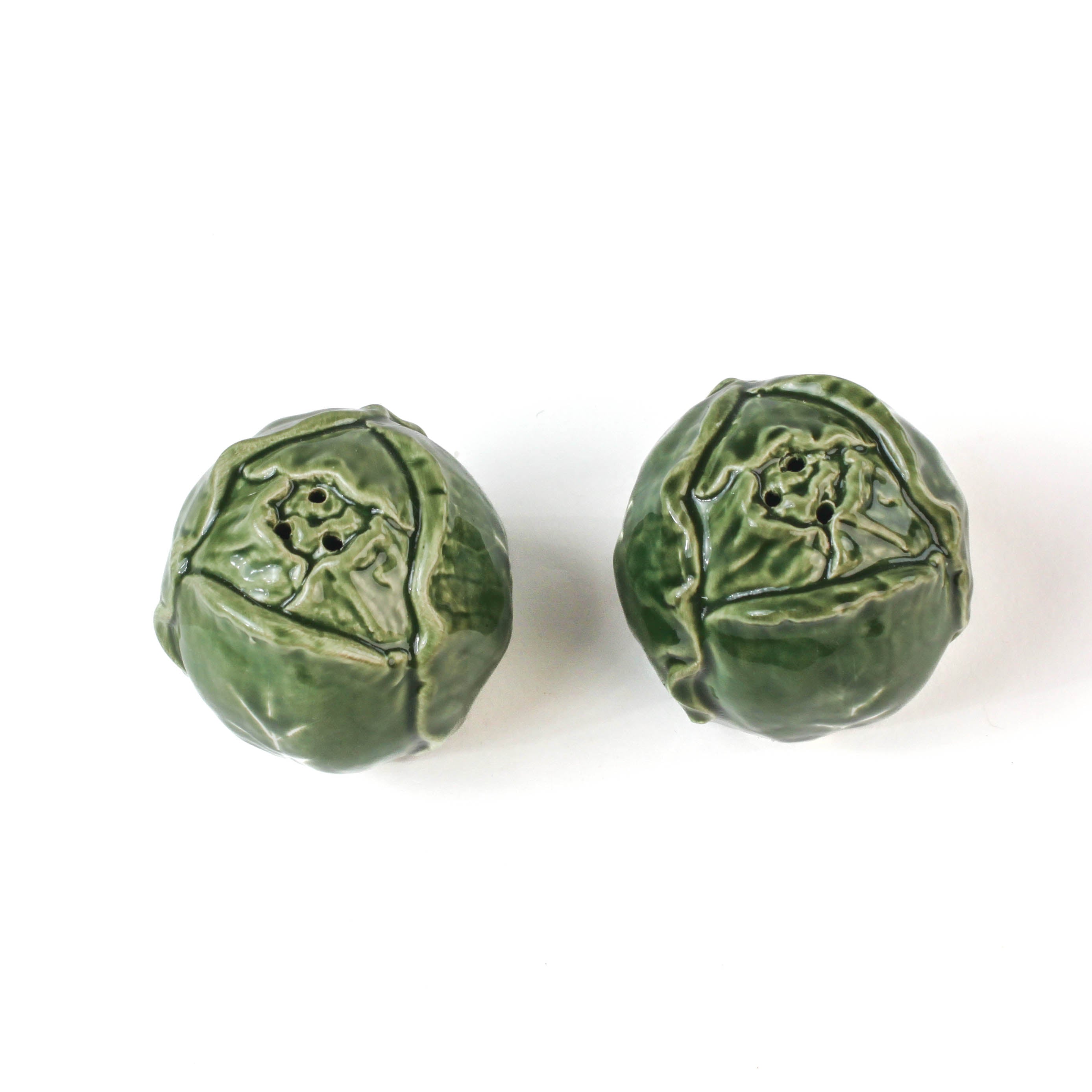 a pair of cabbage leaf salt and pepper shakers from madcap cottage showing the top
