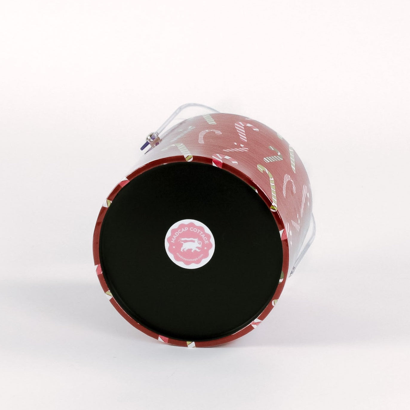bottom of a Dancing Candy Canes, a red acrylic Christmas ice bucket covered in a candy can motif fabric