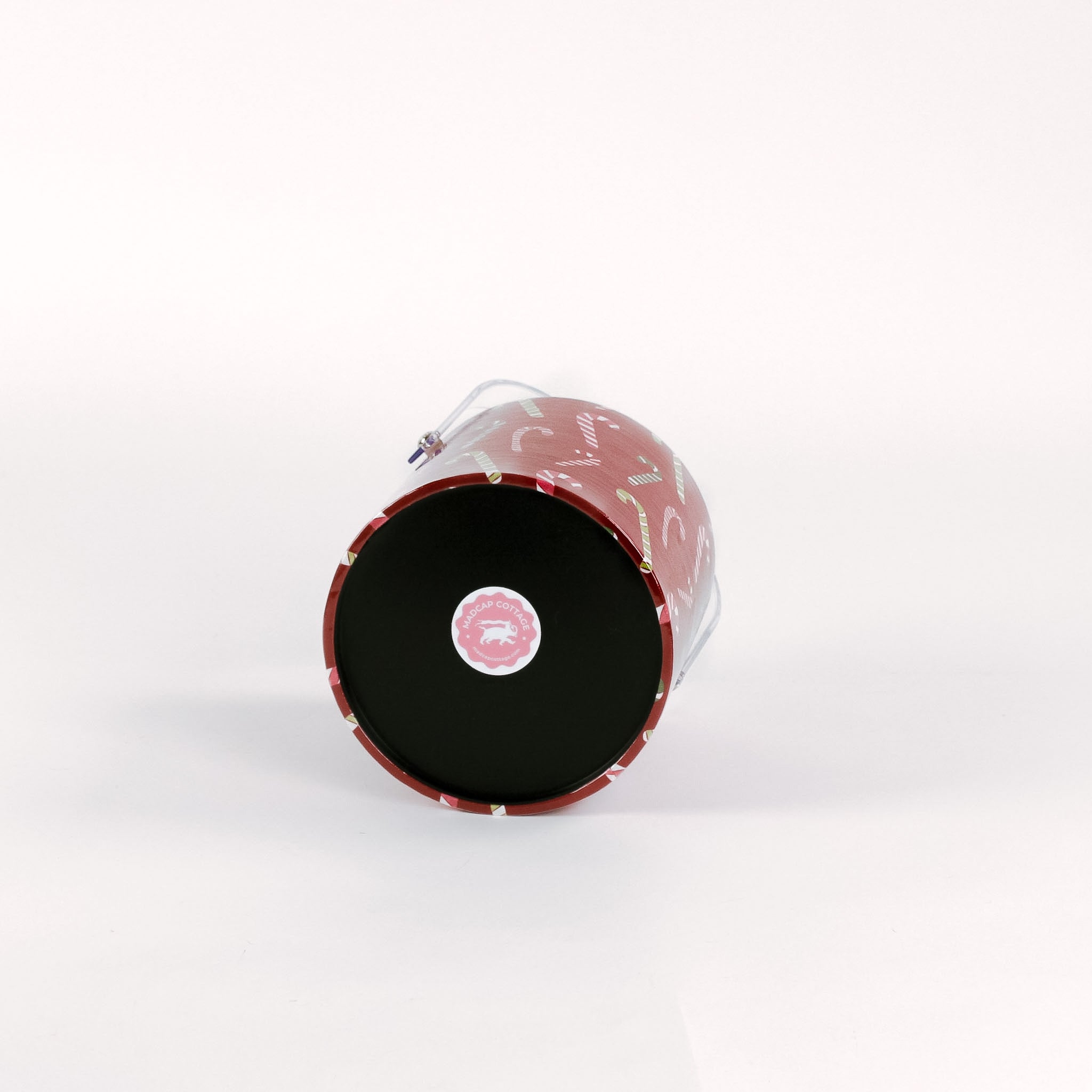 bottom of a Dancing Candy Canes, a red acrylic Christmas ice bucket covered in a candy can motif fabric
