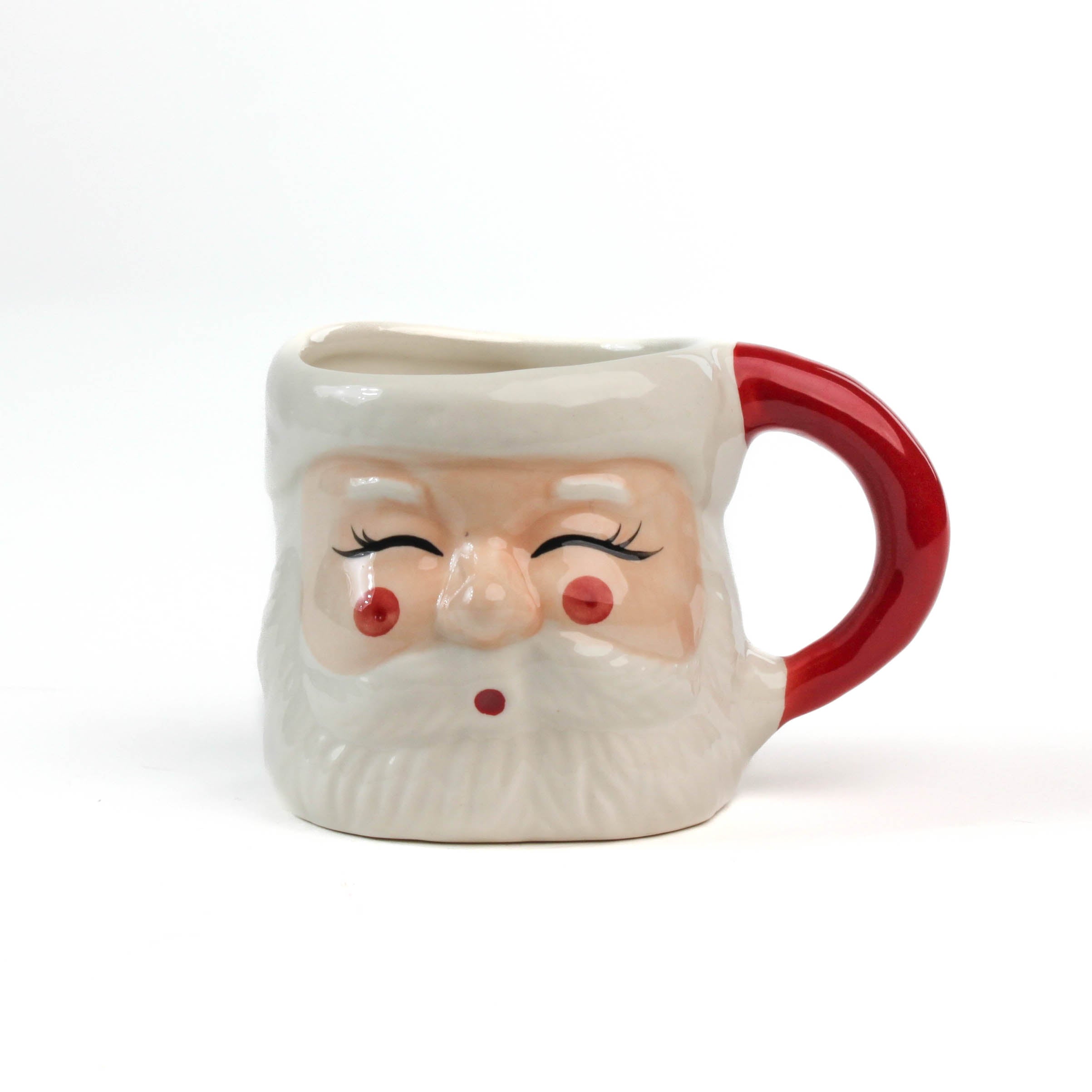 Ceramic Christmas santa mug with a jolly santa face design with red cheeks and a red handle on a white background