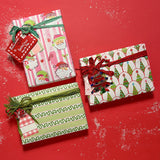 Three christmas gifts wrapped in colorful christmas wrapping paper from Madcap Cottage on a red background.
