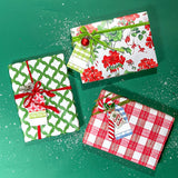 Three christmas gifts wrapped in colorful christmas wrapping paper from Madcap Cottage on a green background.