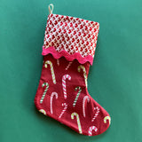 A red christmas stocking printed with candy canes