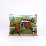 a hooked wool derby day pillow featuring a brown horse and mulitcolor jockey