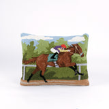 a hooked wool derby day pillow featuring a brown horse and mulitcolor jockey