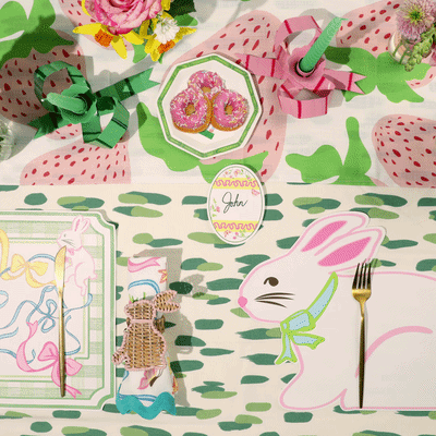 a white easter bunny placemat gliding across a colourful spring tablescape. 