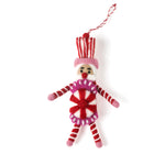 a madcap cottage Christmas felt nutcracker ornament in red and white striped outfit on a white background