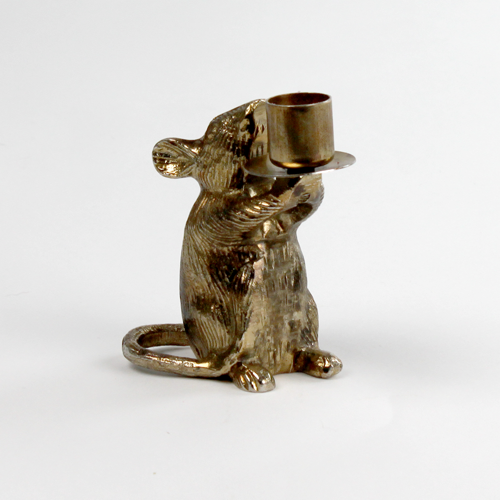 A gold mouse candle holder against a white background