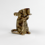 A gold mouse candle holder against a white background