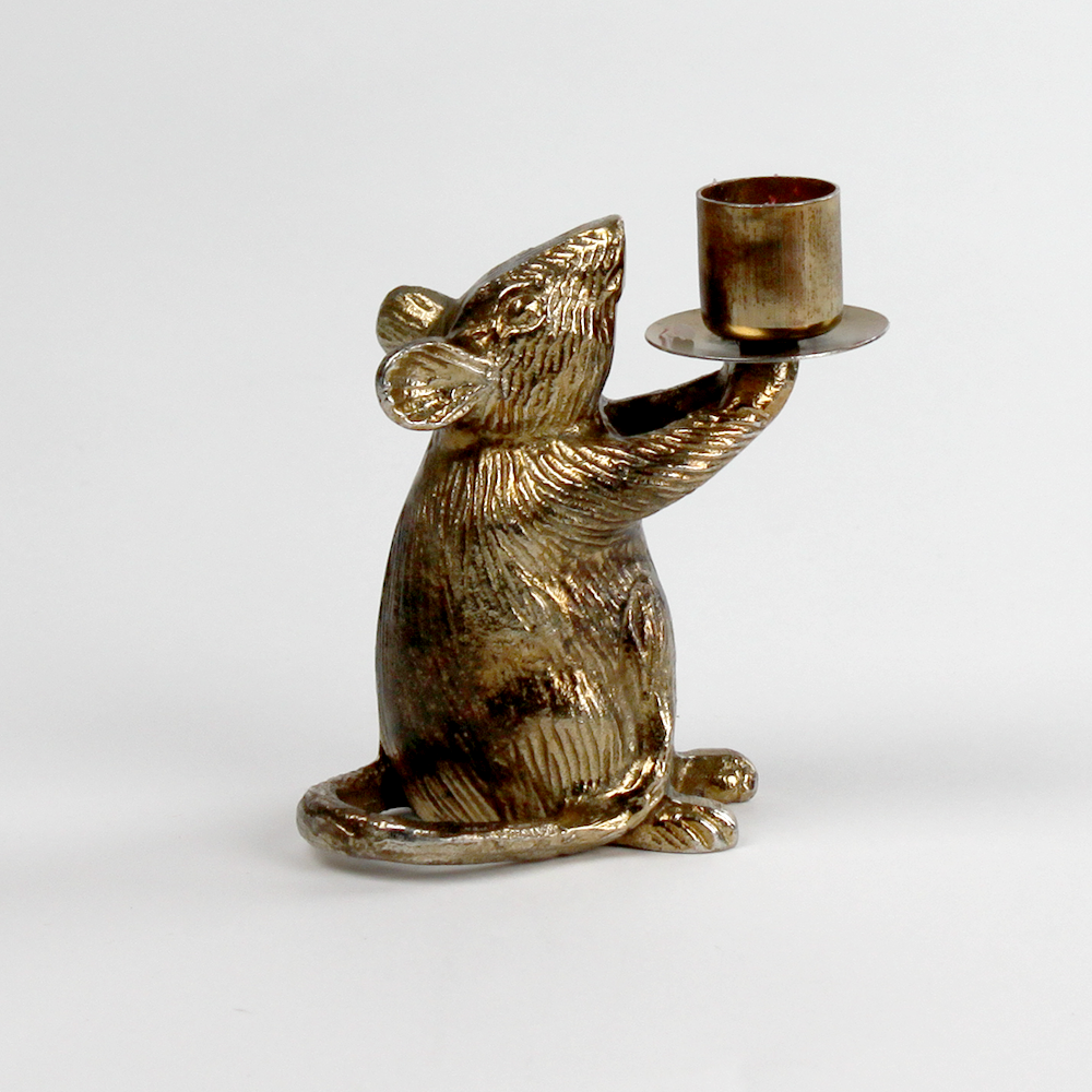 A gold mouse candle holder against a white background