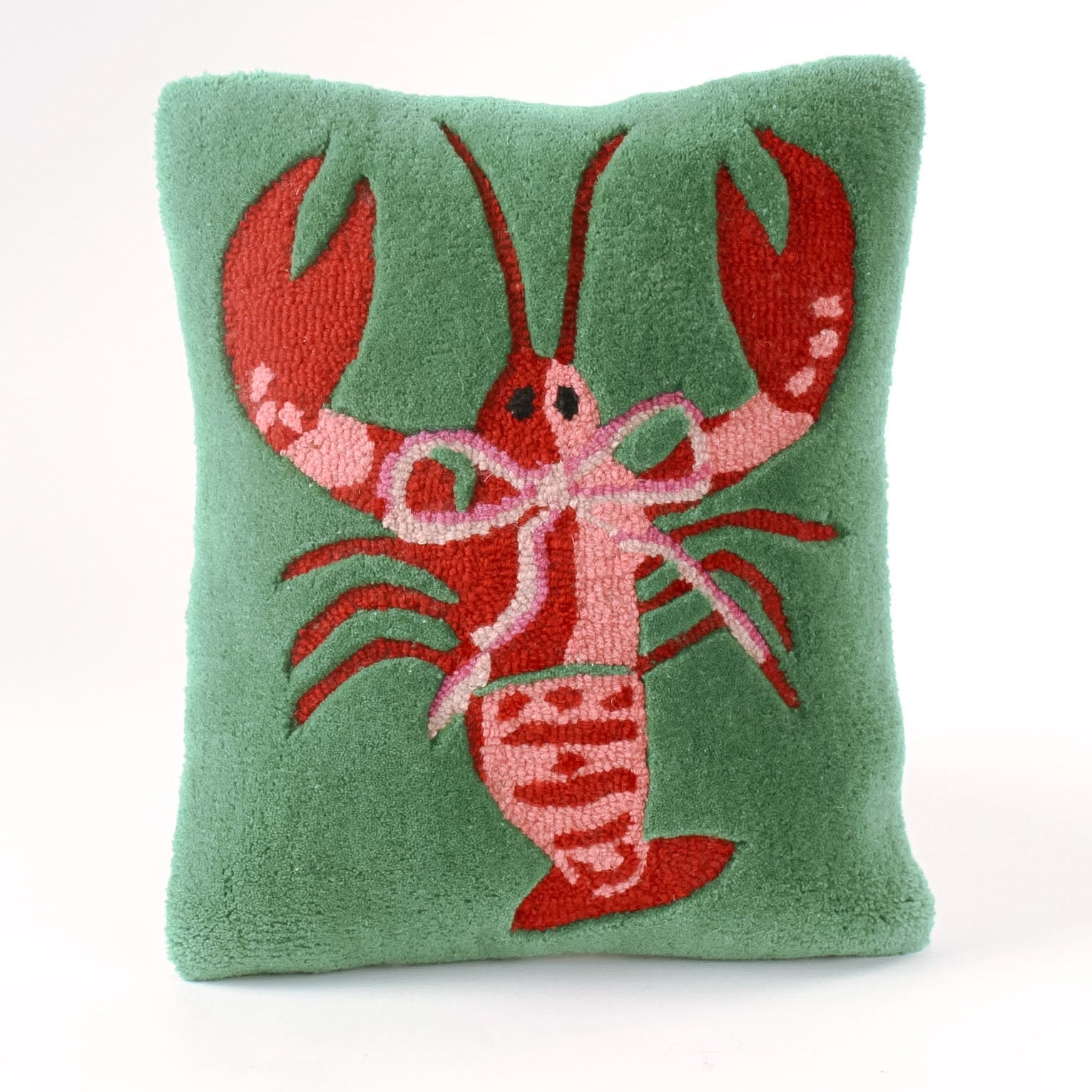 Green pillow with a red lobster design on a white background