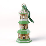 a miniature rattan pagoda chinoiserie christmas ornament with green and pink painted accents from the brand madcap cottage on a white background. 