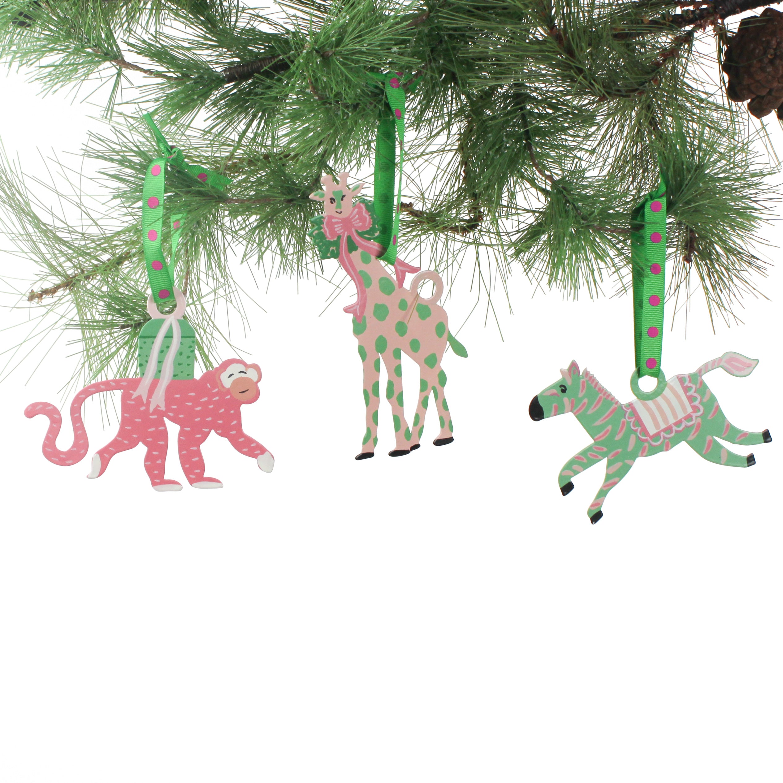 Set of colorful animal-themed Christmas ornaments hanging on a pine branch from Madcap Cottage. 