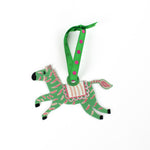 Green and pink zebra ornament on a white background