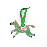 Green and pink zebra ornament on a white background