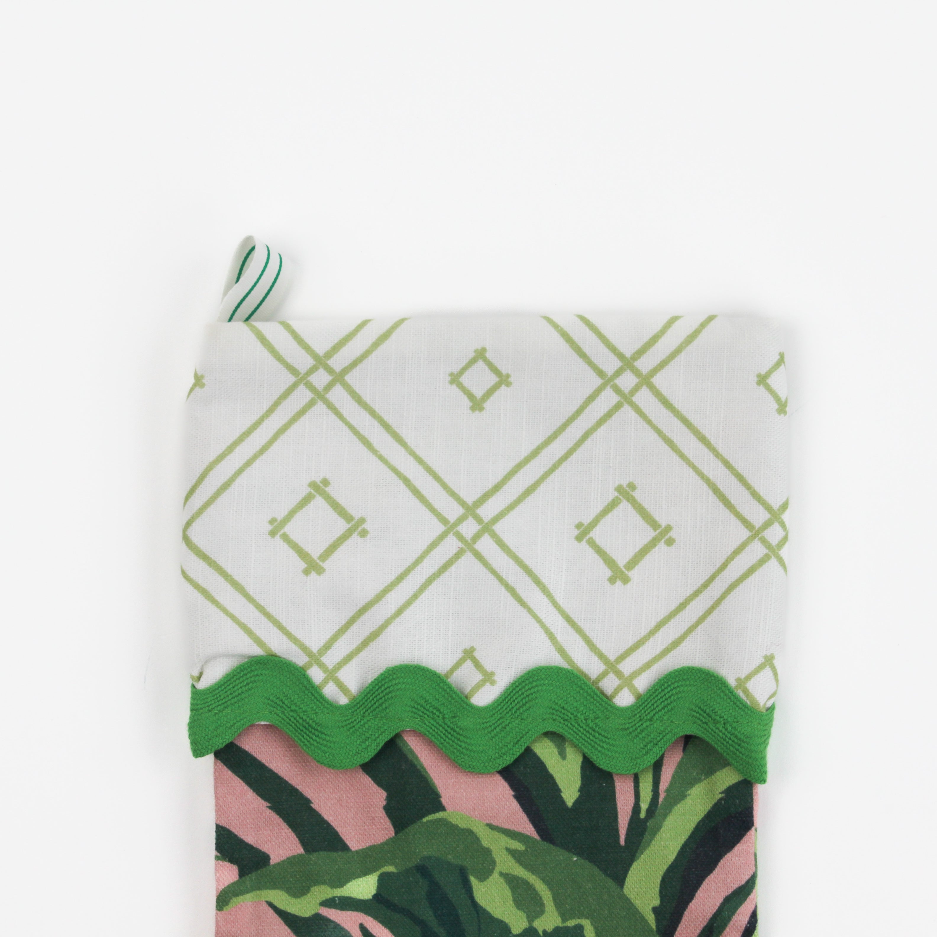 A palm leaf print pink and green Christmas stocking.