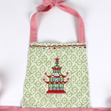 Madcap cottage apron with pagoda design and pink straps on a white background