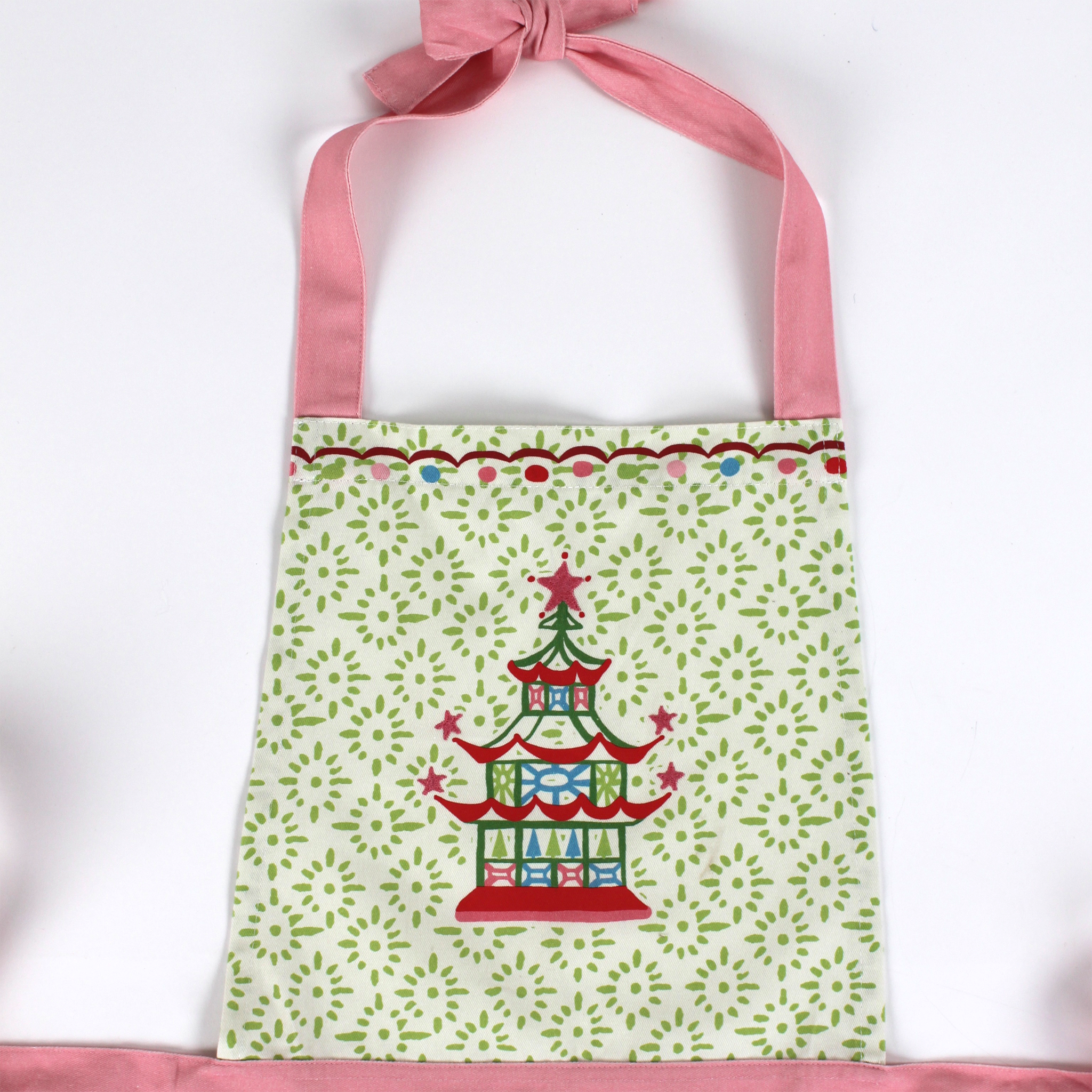 Madcap cottage apron with pagoda design and pink straps on a white background