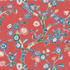 red, Blue and white chinoiserie wallpaper featuring blue and pink cherry blossom motifs on a red background. 