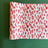 A white and red paper table runner featuring a brushtroke pattern called Club House by Madcap Cottage