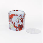 Rock Lobster red and blue ice bucket filled with ice and champagne features a green shell and red lobster print