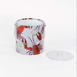 Rock Lobster red and blue ice bucket filled with ice and champagne features a green shell and red lobster print
