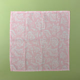 Flat view of Hampton Court shell pink cloth dinner napkin with a white floral motif.