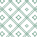 A green bamboo trellis wallpaper design on a white background from Madcap Cottage. 