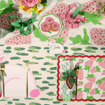 a pink strawberries placemat gliding across a colorful spring themed tablescape.