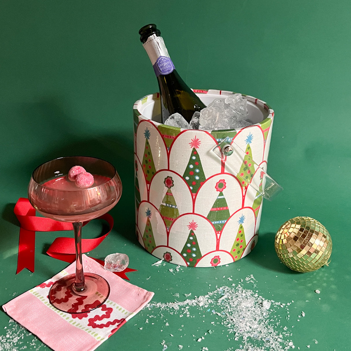 an ice bucket covered in a green christmas tree pattern.