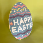 a purple easter egg pillow with text that reads "Happy Easter"
