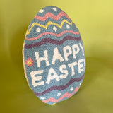 a purple easter egg pillow with text that reads "Happy Easter"