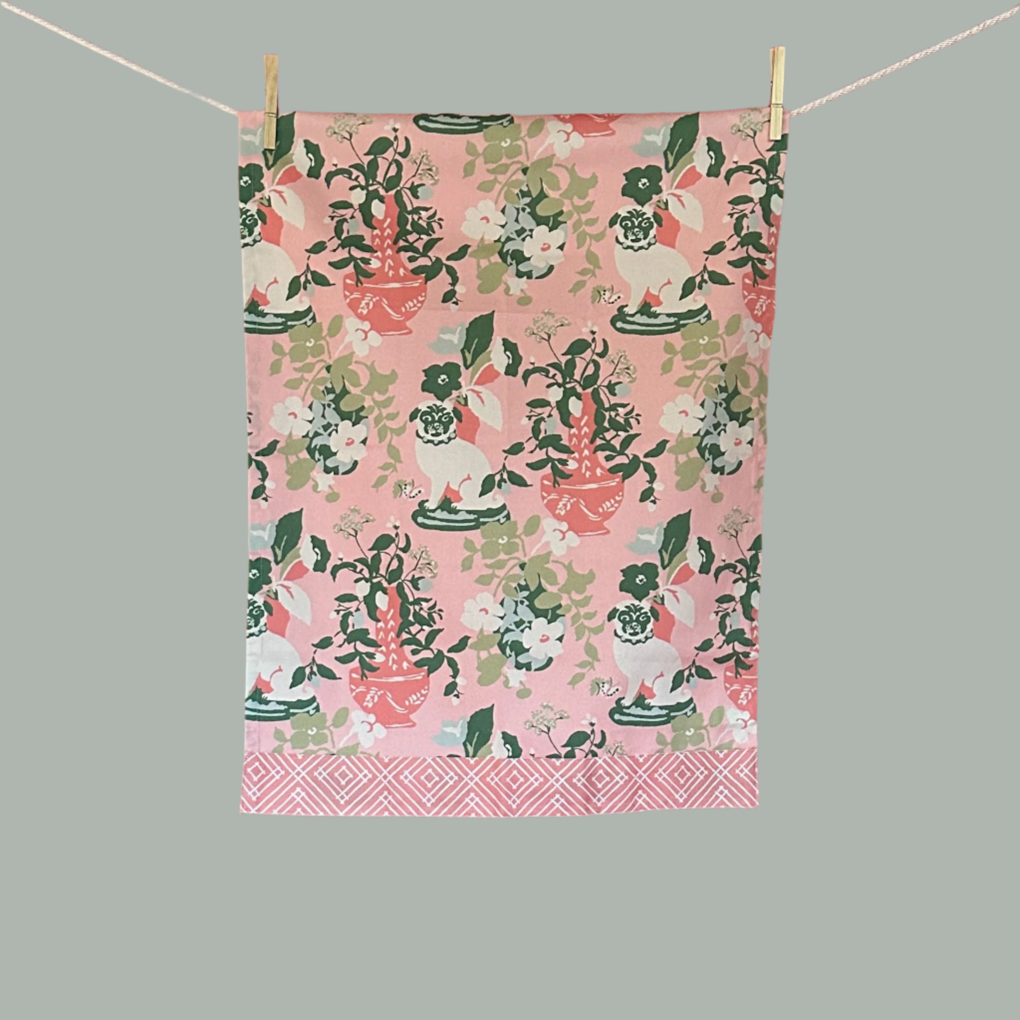 chinoiserie Tea towel with pink background, white pug, and pink vase.