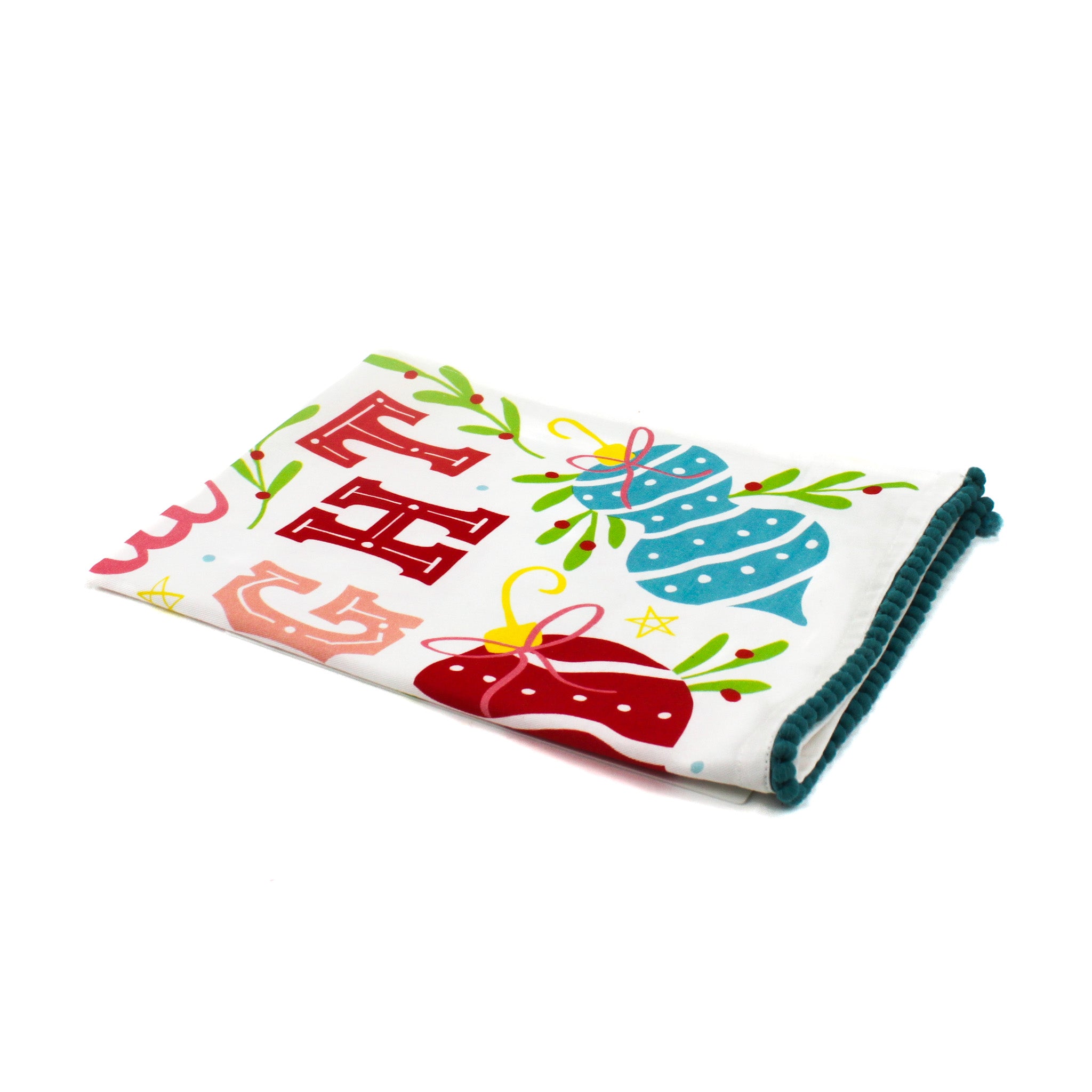 colorful christmas tea towel with with ornament motifs, blue pom pom trim and text that reads "Merry and Bright" against a white background. 