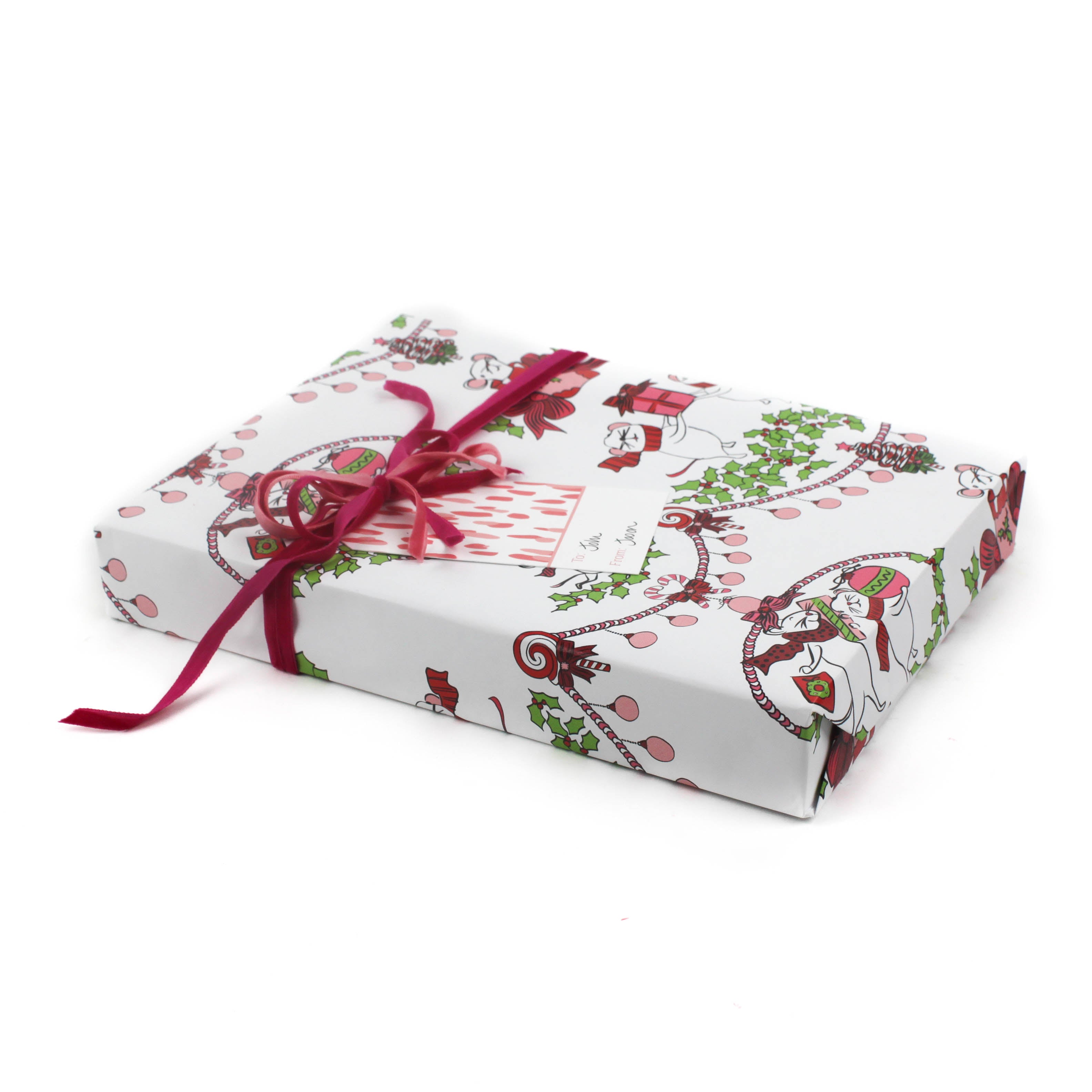 Cute Christmas wrapping paper decorated with white dancing mice holding ornaments and gift bags.