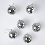 six silver disco ball christmas ornaments on a white background