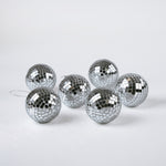 six silver disco ball christmas ornaments on a white background