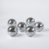 six silver disco ball christmas ornaments on a white background