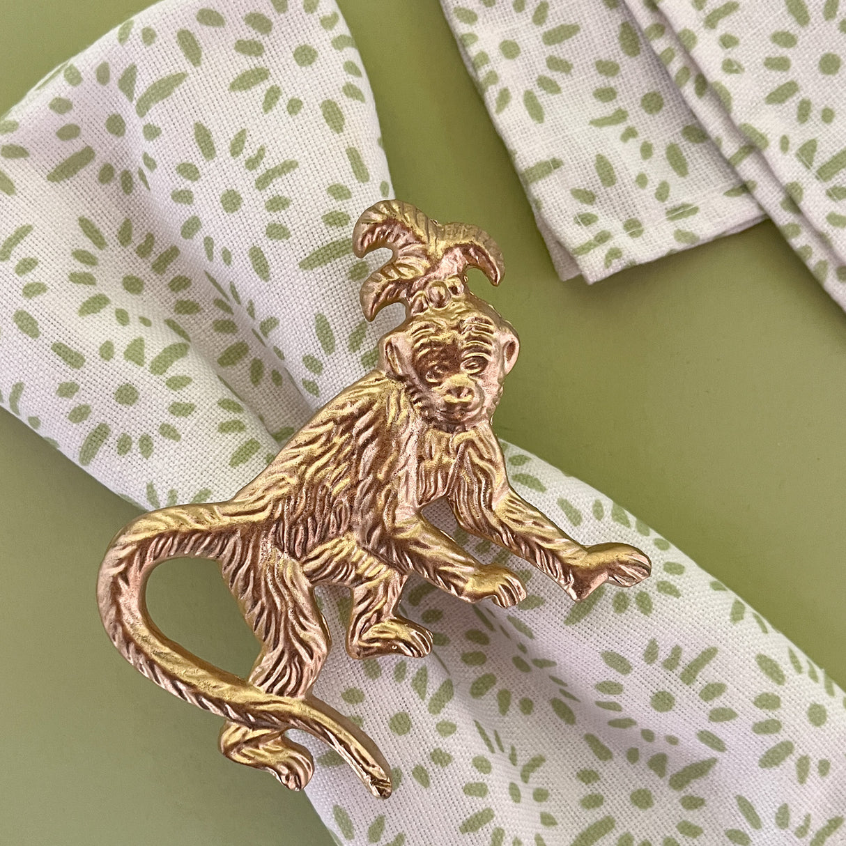 light green and white dinner napkin with monkey dinner napkin ring